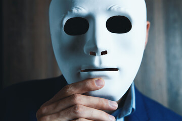 businessman puts on white mask
