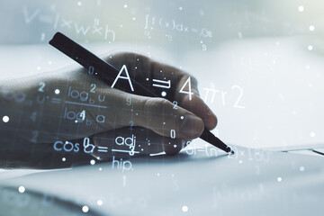 Creative scientific formula concept with man hand writing in notebook on background. Multiexposure
