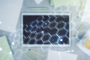 Creative concept of wireless technology with hexagon hologram and modern digital tablet on background, top view. Big data and database concept. Multiexposure