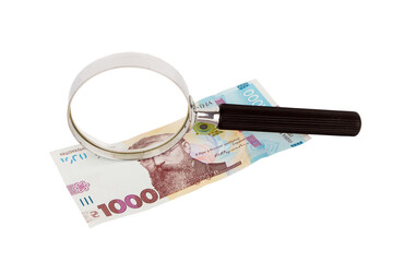 One thousand hryvnias and a magnifying glass, white background