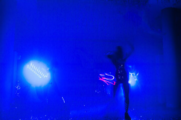 Laser show performance, dancers in suits with colored LED lamp. Very beautiful night club party.