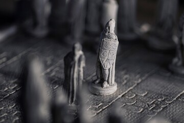 A portrait of two pawns facing eachother in the beginning of a strategic game of chess. The duel...