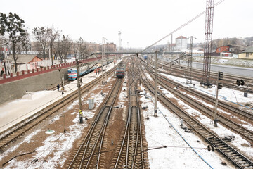 Railway station and crossing railway track. Platform and electric train. Transportation background