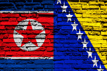 Flag of North Korea and Bosnia on brick wall