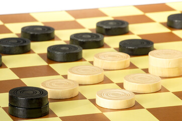 Obraz na płótnie Canvas checkers or draughts is a board game. Close Up of wooden round checkers. white background with space for text