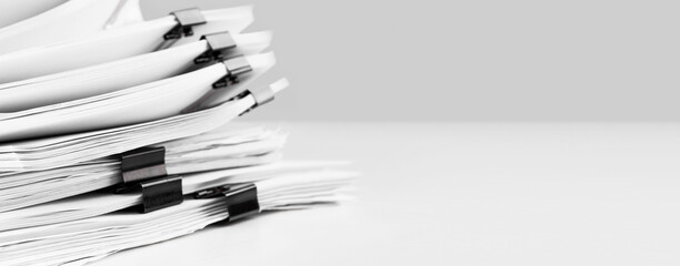 Stack of report paper documents for business desk. Business offices concept, soft focus.
