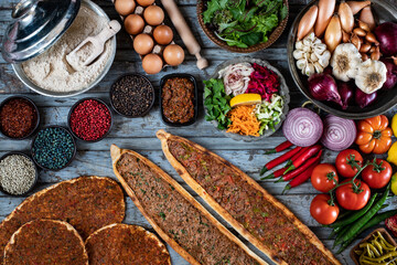 Traditional Turkish food, lahmacun and kiymali and kusbasili pide. Many kinds of traditional food on the rustic table. 