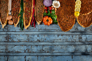 Traditional Turkish food, lahmacun and kiymali and kusbasili pide. Many kinds of traditional food on the rustic table. 