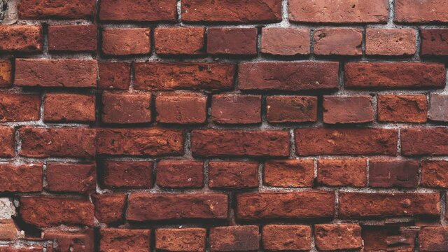 Zooming  red brick wall of an old loft style building. Clean vintage brick wall as texture background. 