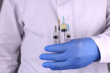 Syringes with a drug in a doctor's hand. Doctor with injection syringes