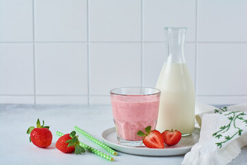 Vegetarian healthy smoothie from strawberry with berries on gray or white concrete background. Selective focus. Space for text.
