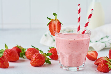 Vegetarian healthy smoothie from strawberry with berries on gray or white concrete background. Selective focus. Space for text.