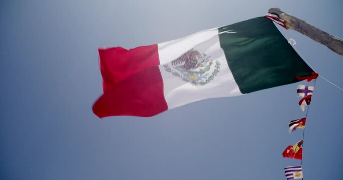 bottom view shot showing a mexican flag hoist in slow motion