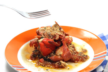 dish with shellfish ragout and lobster pieces