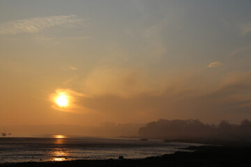 Sunrise in winter over Orwell River near Ipswich in Suffolk, East of England