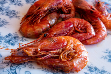 Red prawns cooked on the grill, on a plate