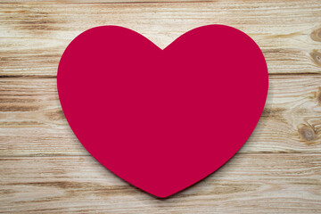 Big red heart on old rustic wooden background. Mock up, template for Valentine`s Day advertising, romantic greeting card.