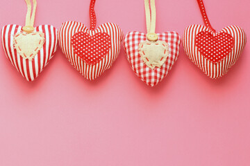 Hearts of fabric on a pink background. Time for lovers' day, Valentine's day.