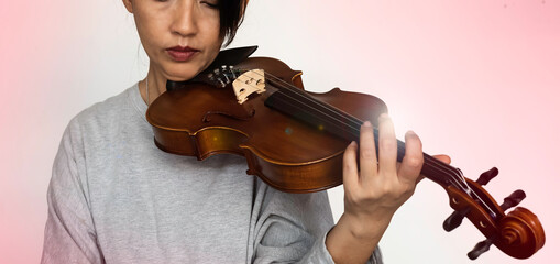 Violin was holding by woman hand,blurred finger pressing on string,Lens flare effect