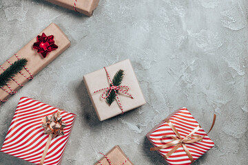 Merry Christmas card or banner made of gift boxes, fir, decorations, sparkles on grey background. Xmas and New Year theme. Flat lay, top view