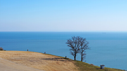 Naklejka na ściany i meble Panoramic view of the Black Sea from the mountain in the city of Kerch under the blue sky on a sunny winter day