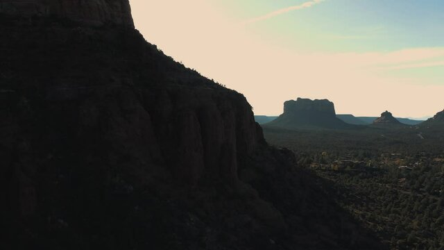 Aerial Drone View of residential areas and roads in Sedona and Oak Creek Canyon in Arizona on a bright and sunny fall day showing unique red rock formations and landscapes 