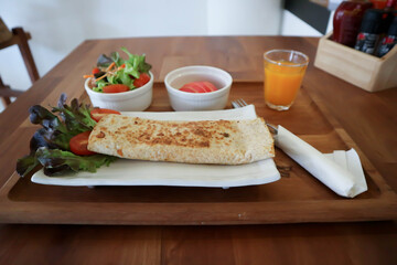 orange juice and taco ,vegetable roll or salad roll or burrito