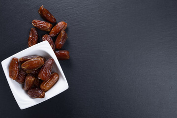 dates. dried fruits on a stone slab. top view. copy space