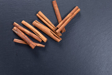cinnamon sticks on a stone slab. top view. copy space