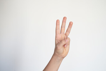 isolated child hand shows the number three. young hand gesture sign.