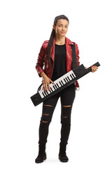 Fototapeta premium Full length portrait of a female musician playing a keytar and standing