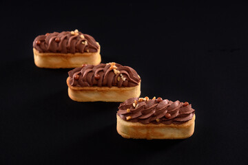 Long biscuit cookies with chocolate whipped cream.