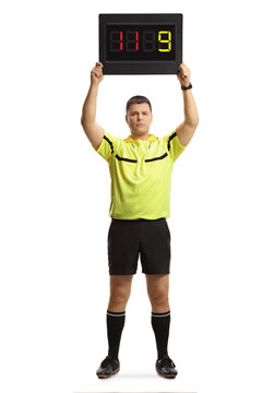 Full length portrait of football referee holding a substitute board