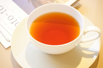 Cup of English Tea isolated on white saucer with Paper magazine - 紅茶 白いカップ、ソーサーと新聞