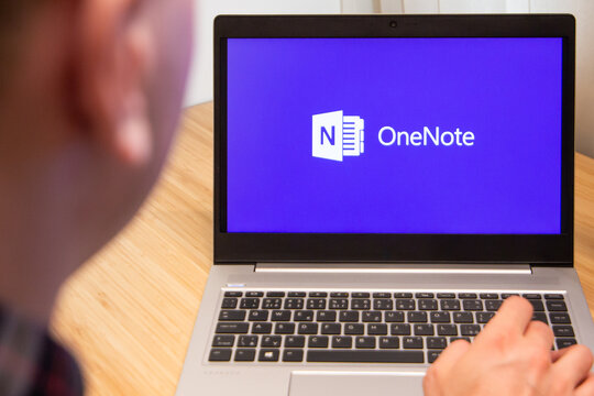 OneNote is used by a man on the laptop. Microsoft customer used computer software. New product is tested by IT specialist. San Francisco, February 2020.