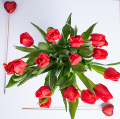 St Valentines day composition with bouquet of tullips and two red hearts