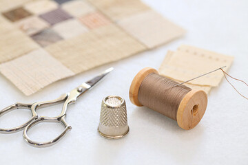 Quilt handmade craft accessories on white fabric