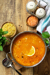 Turkish cuisine. Traditional soup with rice, lentils and mint on a rustic table. Top view flat lay. Copy space.