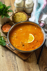 Turkish cuisine. Traditional soup with rice, lentils and mint on a rustic table. Copy space.