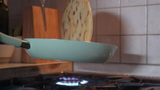 Caucasian man rolling a coloured pan, homemade cheese pie in it 120fps