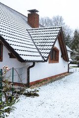 old house in the snow. House with large garden covered with wet snow. Beginning of winter