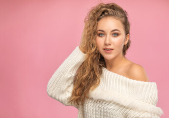 Beautiful red-haired girl with beautiful makeup, with clean skin, long hair in a winter sweater. New Year concept