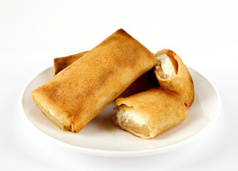 Pancakes stuffed with cottage cheese on a white plate