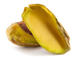 The pistachio core and half are isolated on a white background.
