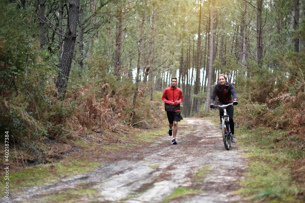 Wall mural 
cute young couple doing sport in forest paths