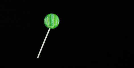 Candy lollipop macro photo, desert ideas on dark black isolated background