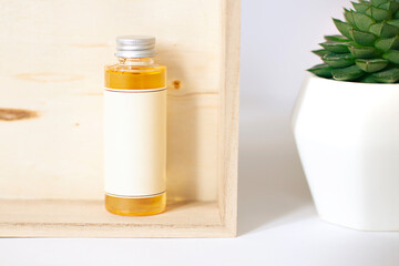 Cosmetic spa bottle in the bathroom on the wooden background. Beauty close up