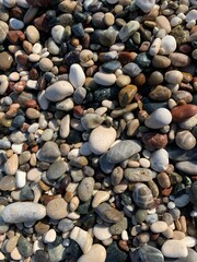 Small wet sea pebbles background