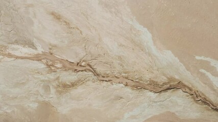 Aerial above dry river in arid landscape of Iceland, Hverarönd