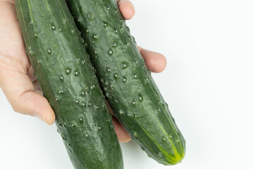 Whole fresh cucumbers isolated above white background